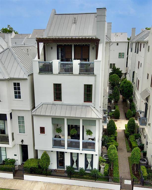 Sophisticated luxury in this four-story free-standing home features a metal roof, 3 balconies and a well-maintained, turfed side garden. Ideal for urban living with elegance.