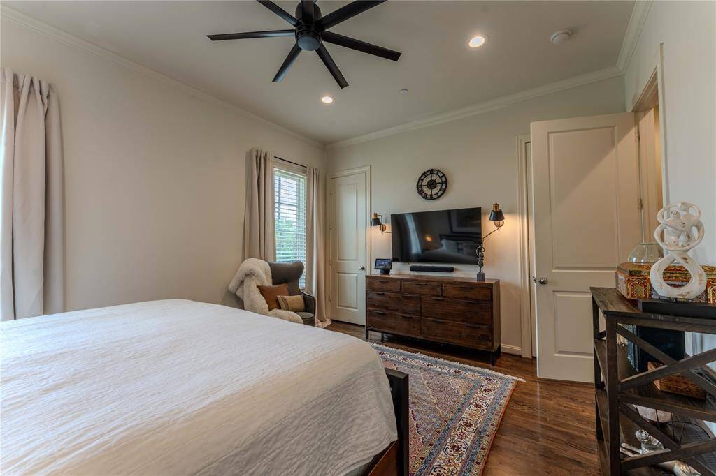 This primary bedroom is more than ample on space and is enhanced with hardwood floors,  a modern ceiling fan, recessed lighting, extra closet space, and sound-proof windows.  You'll rest well in your private retreat.