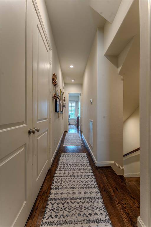 The utility room is super conveniently located on the same floor as the primary bedroom.  Owners have created more storage and space by utilizing a stacked W+D.