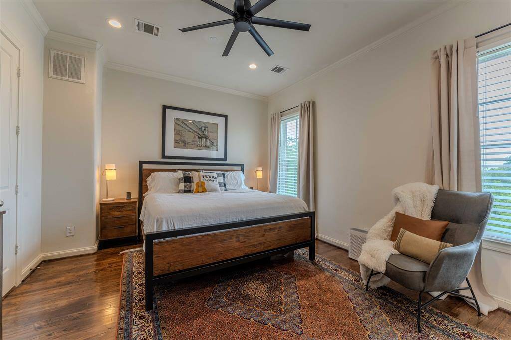 Spacious primary with crown molding, recessed lighting, hardwood floors, natural lighting, fantastic ceilings fan and bonus closet space.