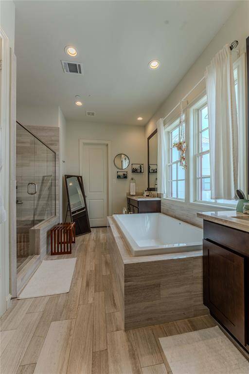 Soak your cares away!!  This primary ensuite offers a gigantic soaking tub, split double vanities, roomy walk-in shower, private water closet, and deluxe dressing closet with plenty of space.