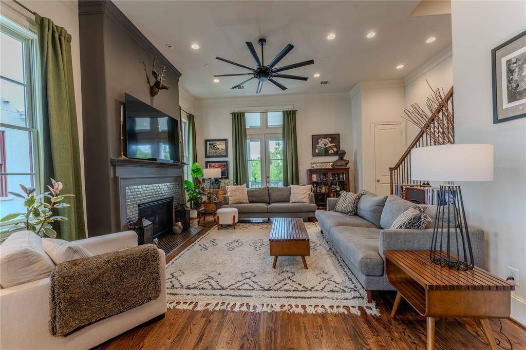 Stylish and spacious, this main floor living does not disappoint.  Over-sized base boards, recessed lighting, natural lighting, accented fire place wall with sleek tile surround, luxurious hardwood flooring, built in storage/bookshelf, and access to two balconies making it the perfect place on perfect days.