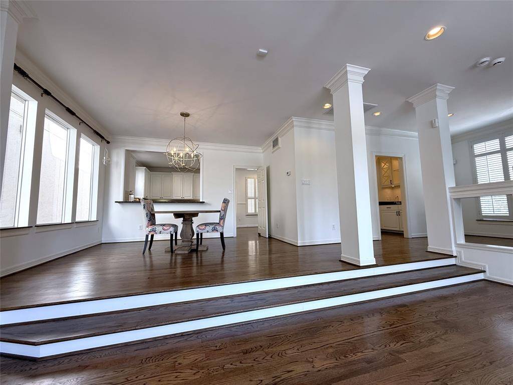 From tri-windows, natural light flows into the formal dining space.