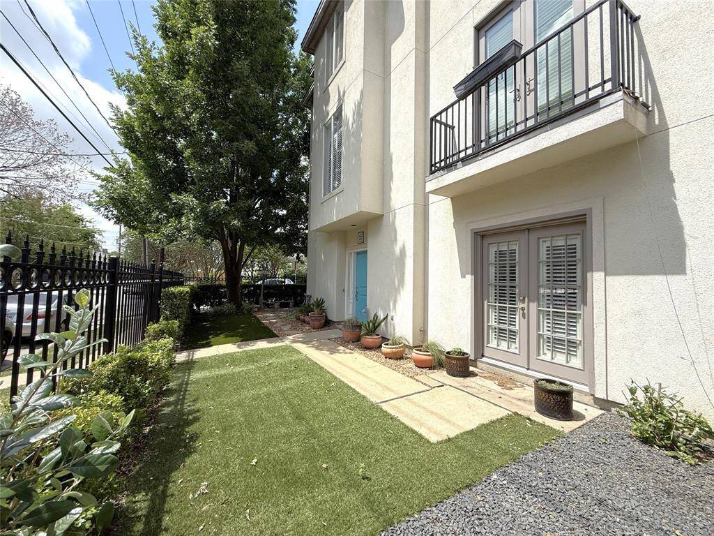 With two pedestrian gates, the yard wraps around to the driveway side of the home.