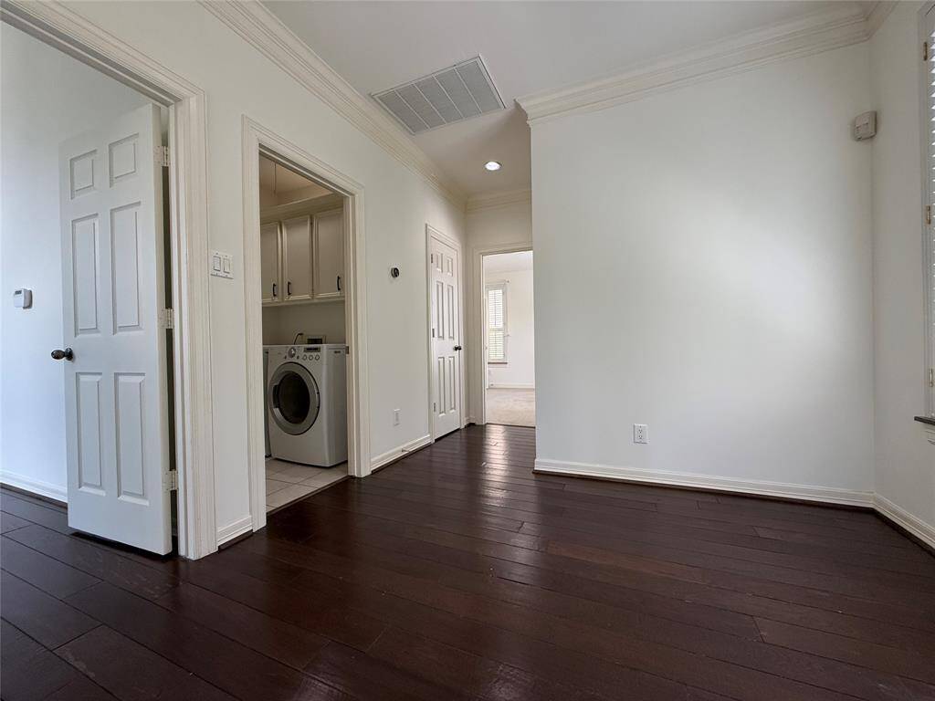 Just outside the primary suite is another bonus space measuring approximately 10x8. This space could be utilized for a home office. From the bonus space, a door opens into the laundry room.
