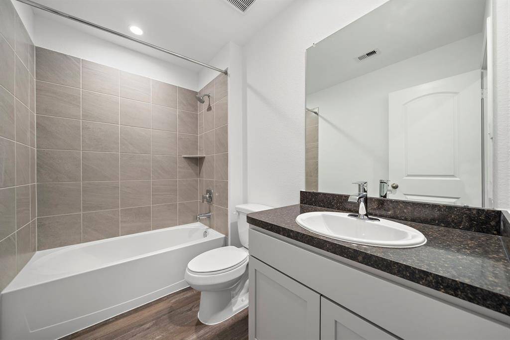 The hall bath is conveniently located between the two secondary bedrooms.