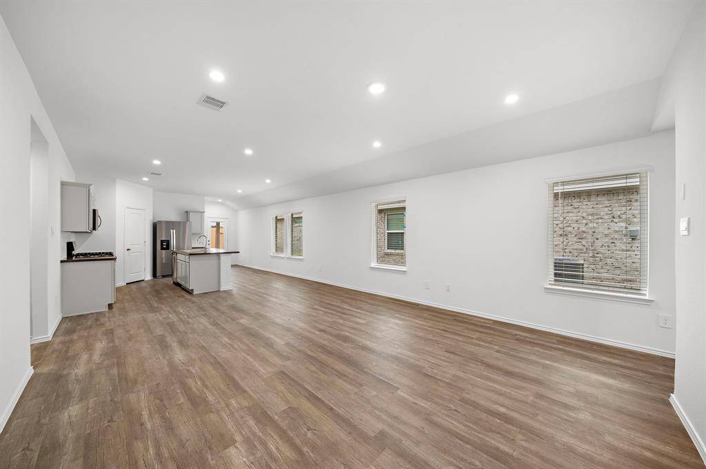 Spacious living room with tons of natural light and plenty of space for a dining table.