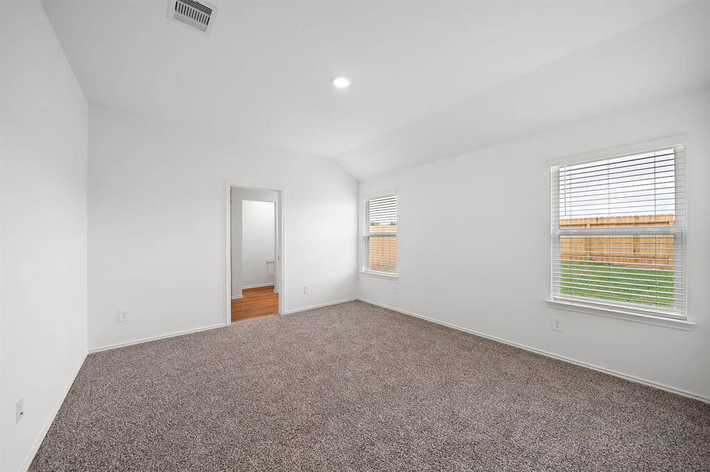 Large primary bedroom overlooking the backyard.