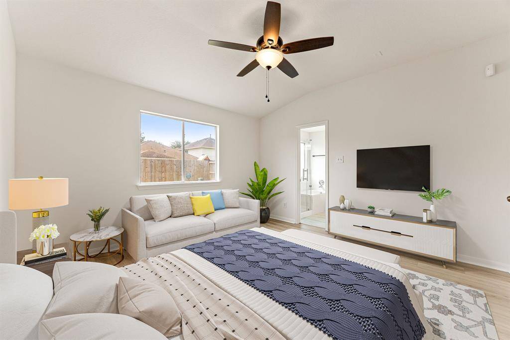 What a wonderful place to come home to! This stunning primary suite greets you with gorgeous wood like floors, neutral paint, high ceiling, ceiling fan with lighting, large windows with blinds allowing in natural light brightening up this spacious primary bedroom with extra space for a seating area.