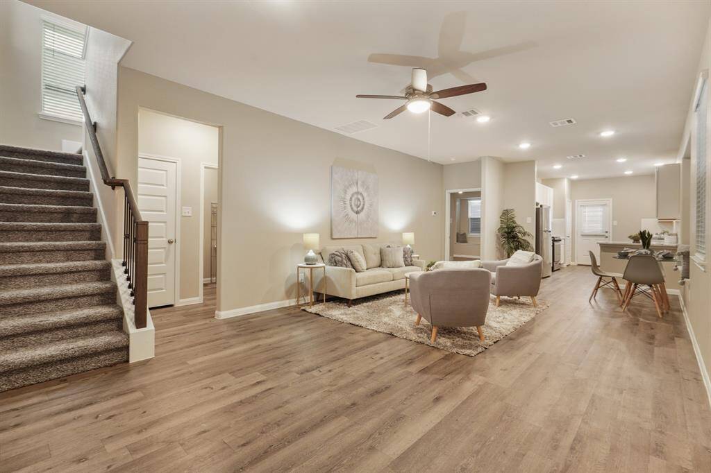 Step inside to a spacious living area filled with natural light, luxury vinyl plank flooring, and soft neutral finishes. This open layout flows effortlessly into the dining and kitchen spaces, with the private primary suite also thoughtfully located on the main floor.