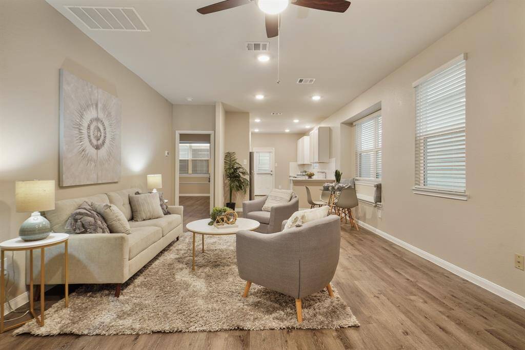 This open, airy family room is designed for comfort and connection, featuring luxury vinyl plank flooring, recessed lighting, large windows, and a ceiling fan for year-round comfort. Whether you’re relaxing or entertaining, the flexible layout adapts beautifully to your lifestyle.