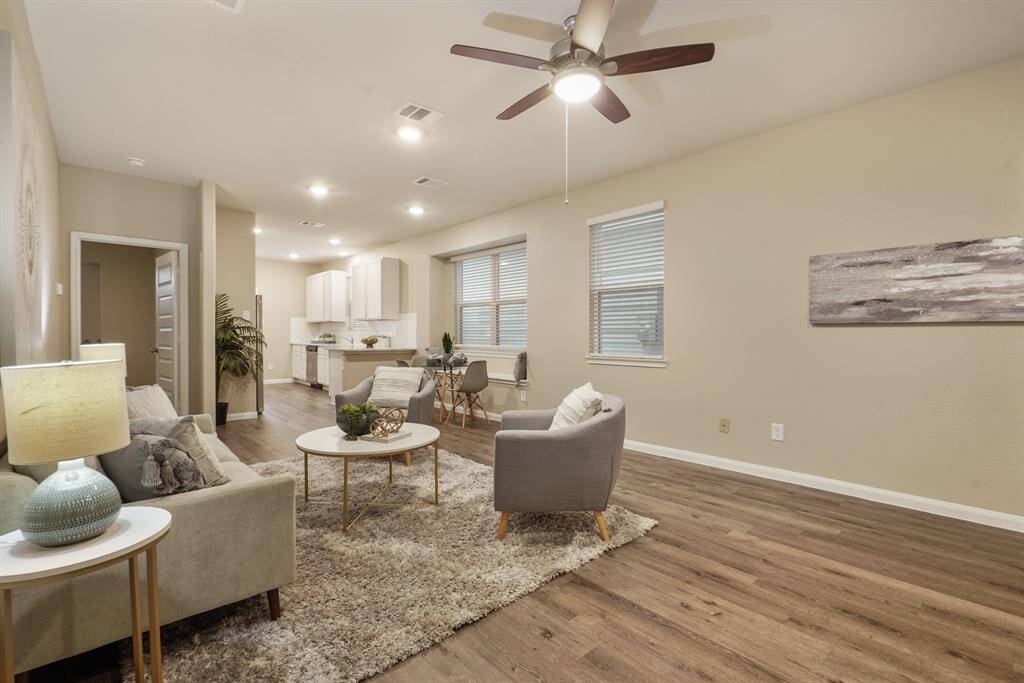 Enjoy an open-concept layout where the living room, dining nook, and kitchen flow together effortlessly, creating the perfect space for everyday living. With gorgeous luxury vinyl plank flooring and crisp, modern finishes, this area is both functional and inviting.