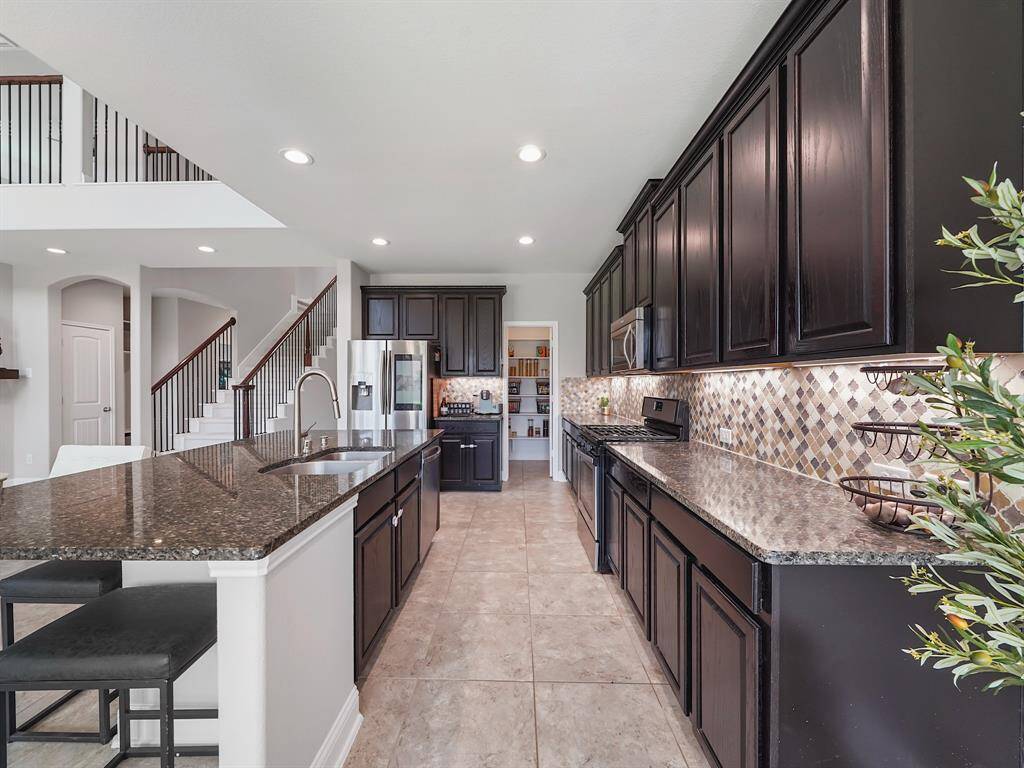 The kitchen boasts ample cabinet and counter space, providing a highly functional and organized environment for meal preparation and storage