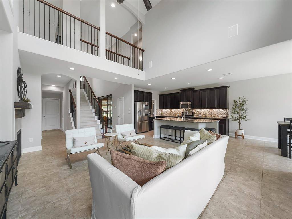 The expansive design allows for seamless flow and an abundance of natural light, creating a warm and inviting atmosphere.