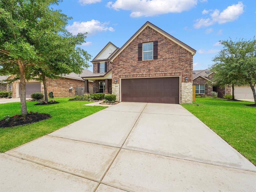 The exterior showcases a gorgeous combination of brick and stone, creating an impressive curb appeal.