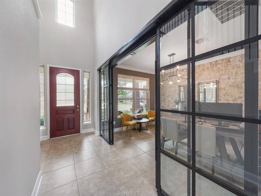 Work from home in style within the dedicated office space, featuring a contemporary barn door entry and a chic brick accent wall.