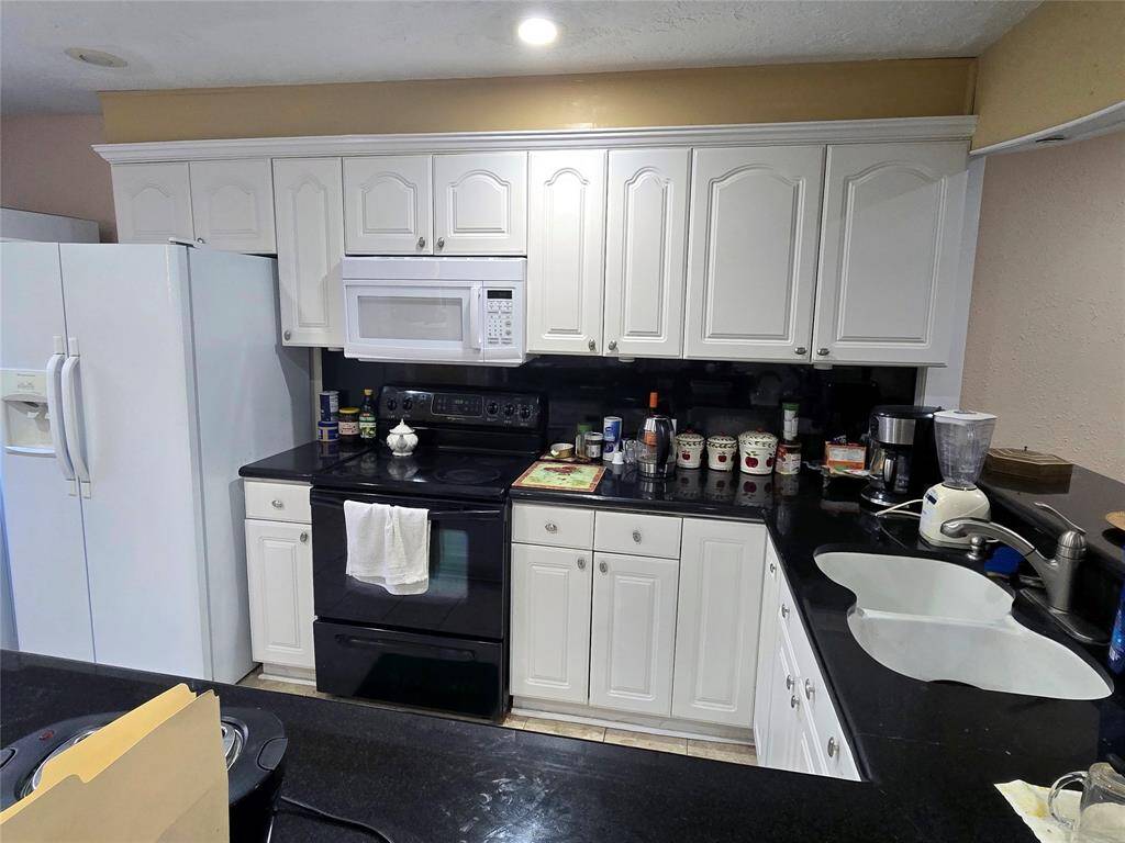 Kitchen includes range, microwave, and dishwasher