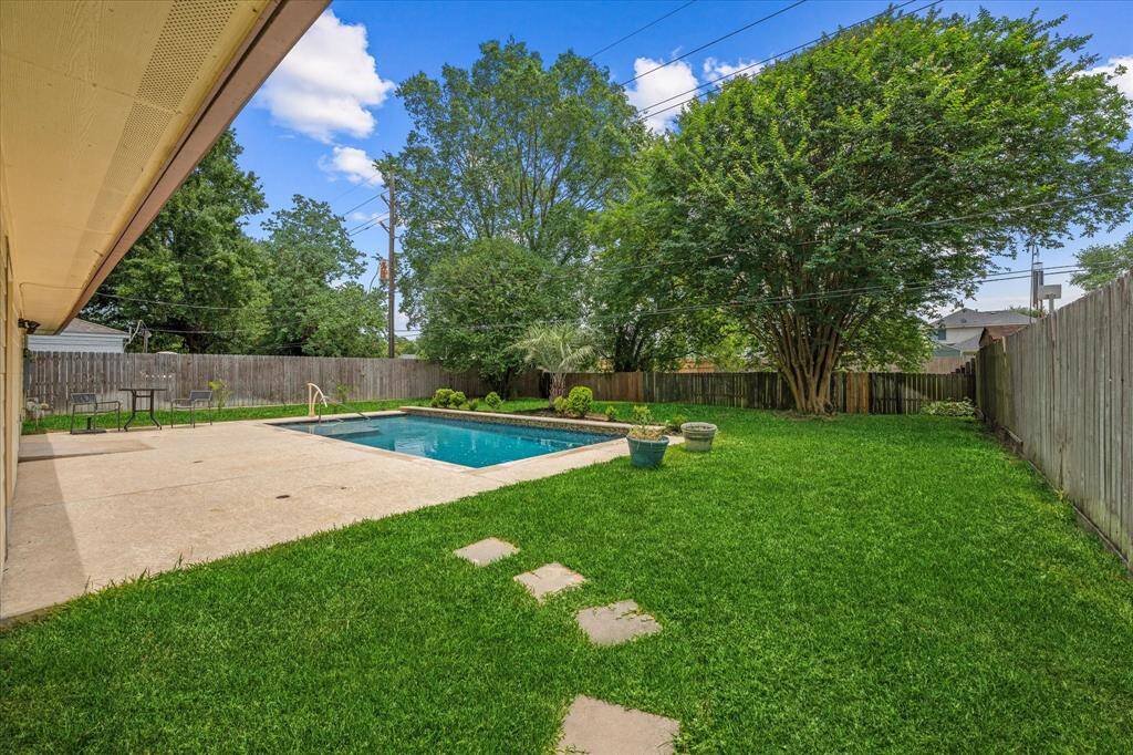 Large backyard with pool and extended patio
