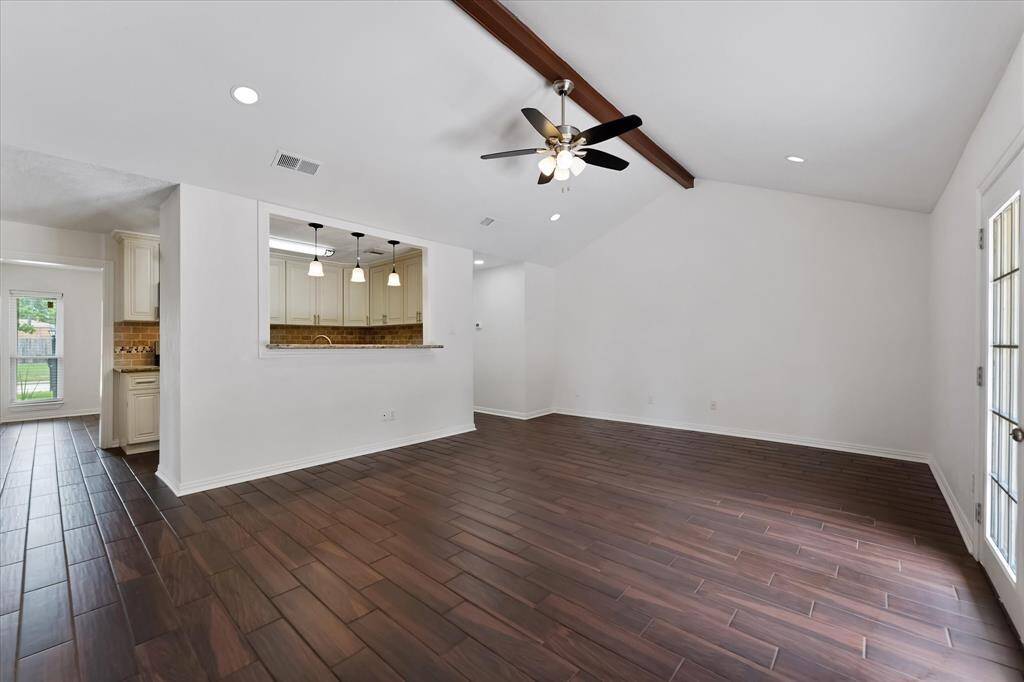 Living room with high, beamed ceiling.