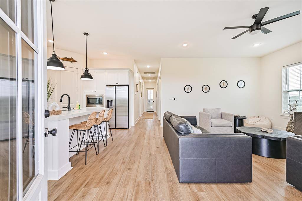View as you enter the beautifully updated home with waterproof laminate flooring throughout, quartz countertops in kitchen, and all set up for short term rental.  Sold FULLY FURNISHED!