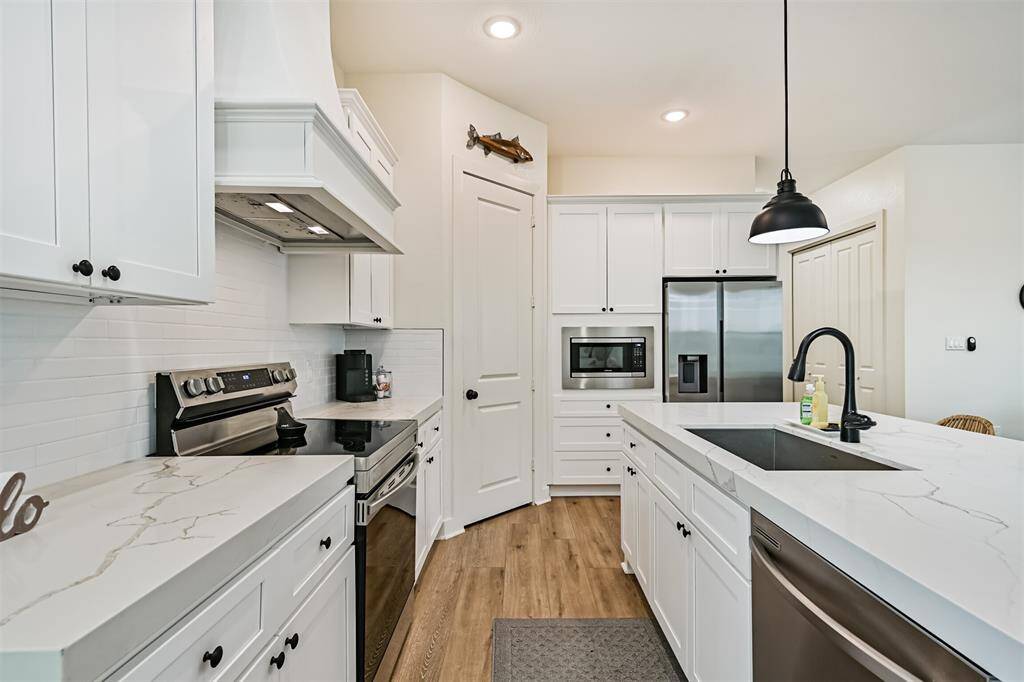 Notice the beautiful quartz countertops.