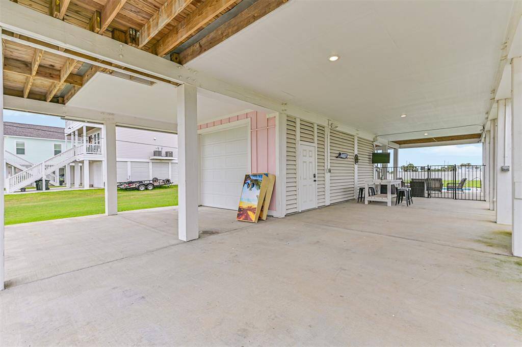 Corn hole anyone?  Entertaining space and access to climate-controlled room with bathroom.  No need to go upstairs when wet from the pool.