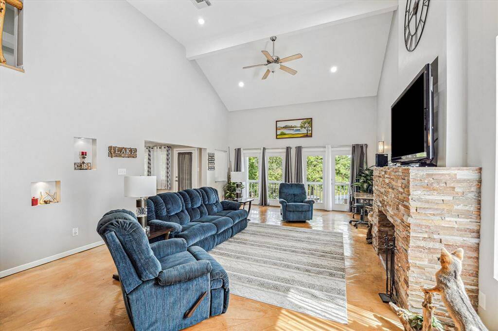 Spacious living room features a fireplace, high ceilings, and beautiful views. Balcony located off of living room.