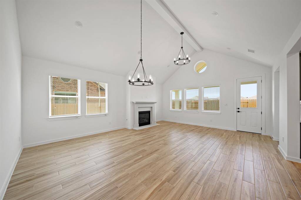 Impressive great room and dining area with high vaulted ceilings (*Photo not of actual home and used for illustration purposes only.)