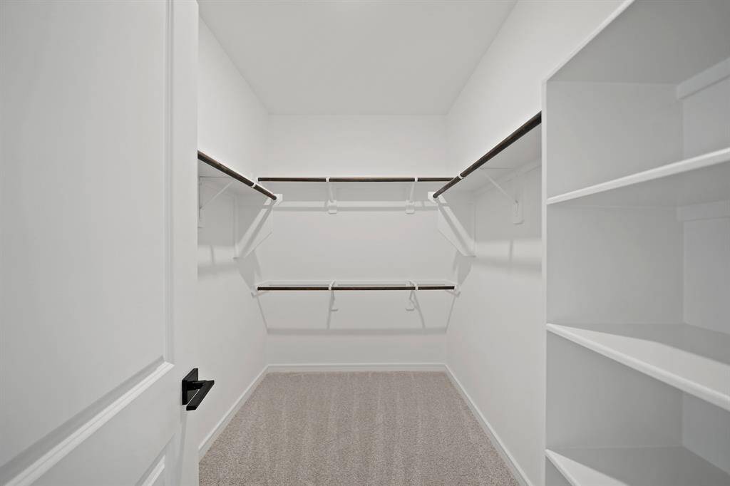 Walk-in closet in the primary suite (*Photo not of actual home and used for illustration purposes only.)