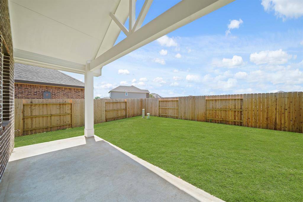 The covered patio provides a perfect space for outdoor relaxation and entertaining