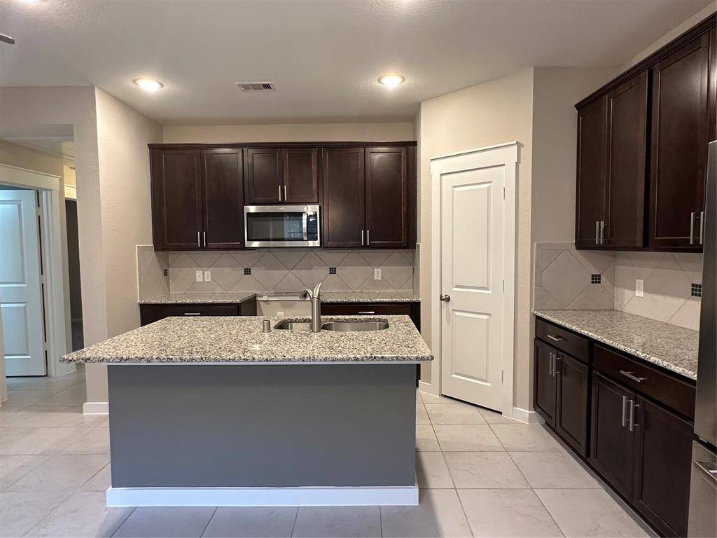 Just to the left of the kitchen, find 2 secondary rooms and a hall bathroom.