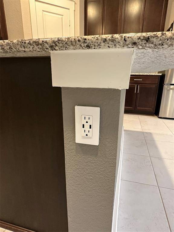 Island includes modern electrical outlet.