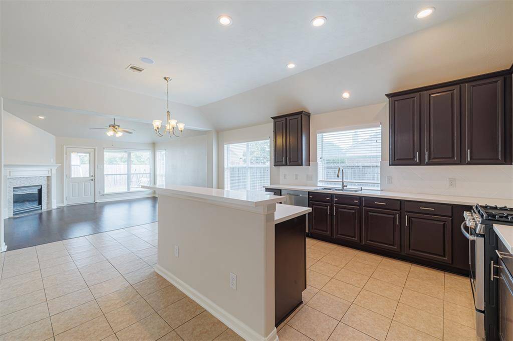 View of the kitchen, breakfast area and family room showing the bright and open floorplan.