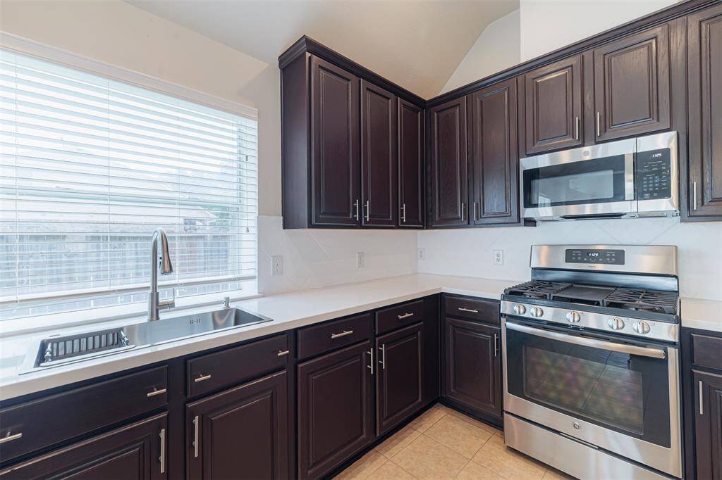 The kitchen also features a farmhouse sink and gas cooking along with a large window that fills the space with natural light.