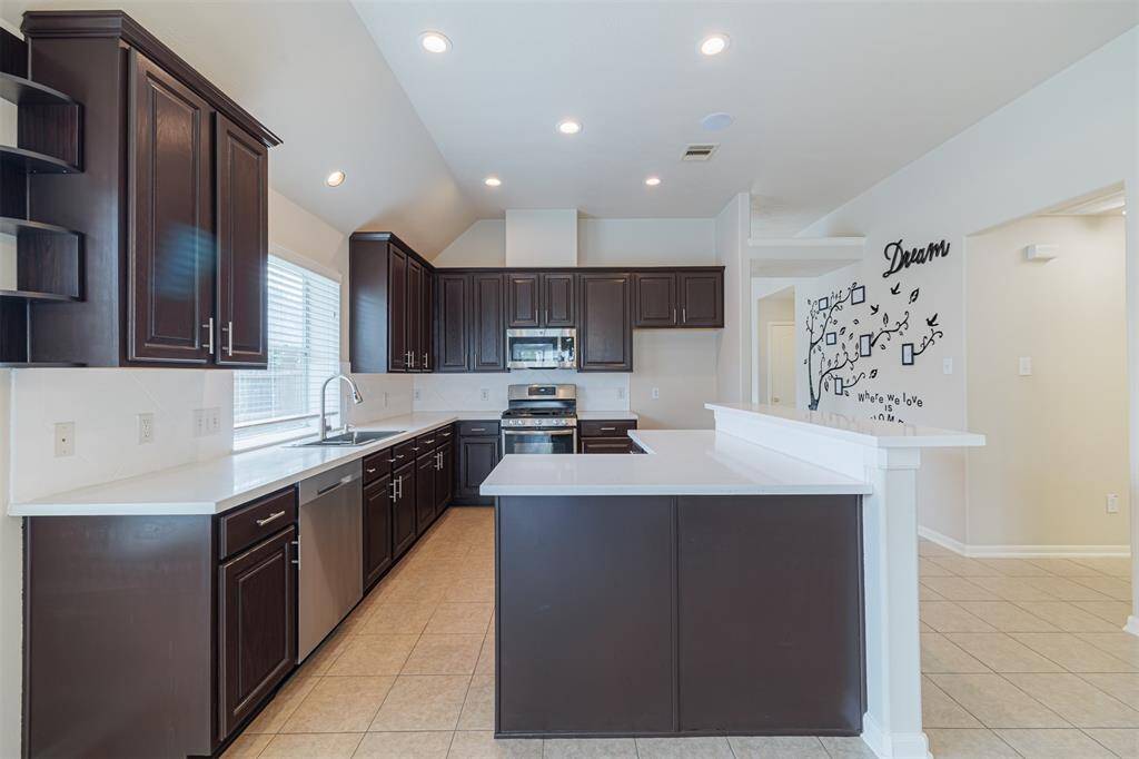 Another view of the kitchen showing the breakfast bar.