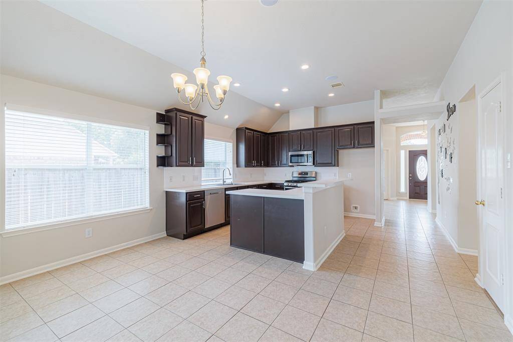 Breakfast area and kitchen are open.