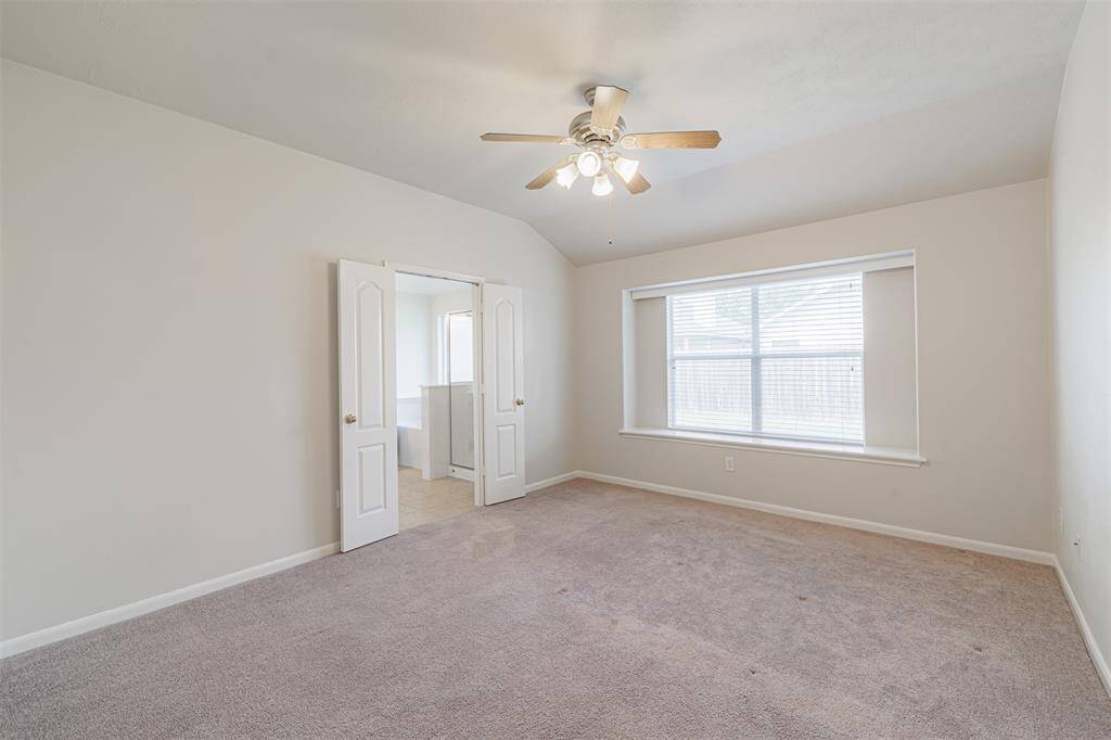 The serene primary suite boasts a spacious walk-in closet, high ceilings and an ensuite bath.