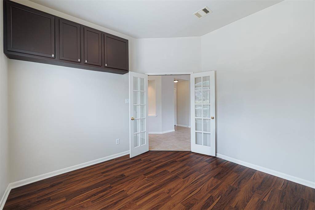 Private study with double French doors and built-in cabinets