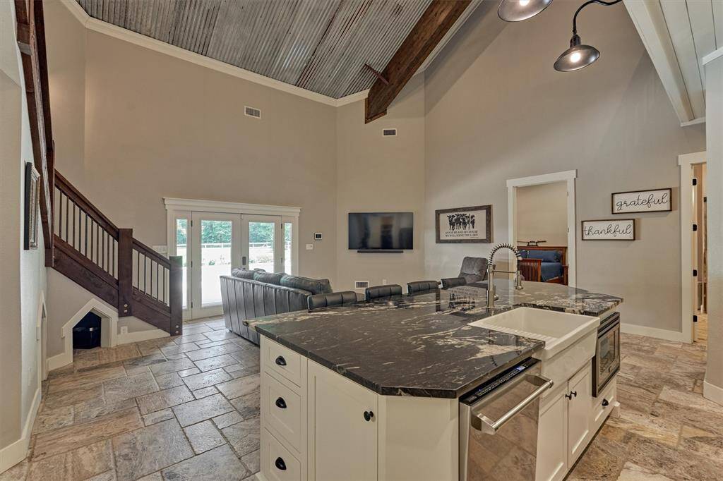 A look back towards the side entry doors reveals the open kitchen and living spaces.