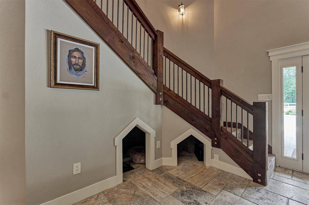 Thoughtfully designed cubbies underneath the stairs create a cozy nook for pets.