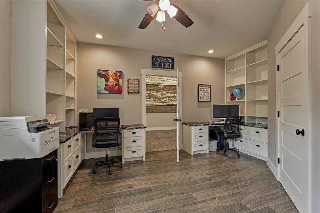 The second-floor office offers versatility and could easily serve as a third bedroom. Custom built-ins create an ideal workspace for a home office or homeschool setup. This room includes two closets, one of which is oversized and insulated, providing excellent storage options.