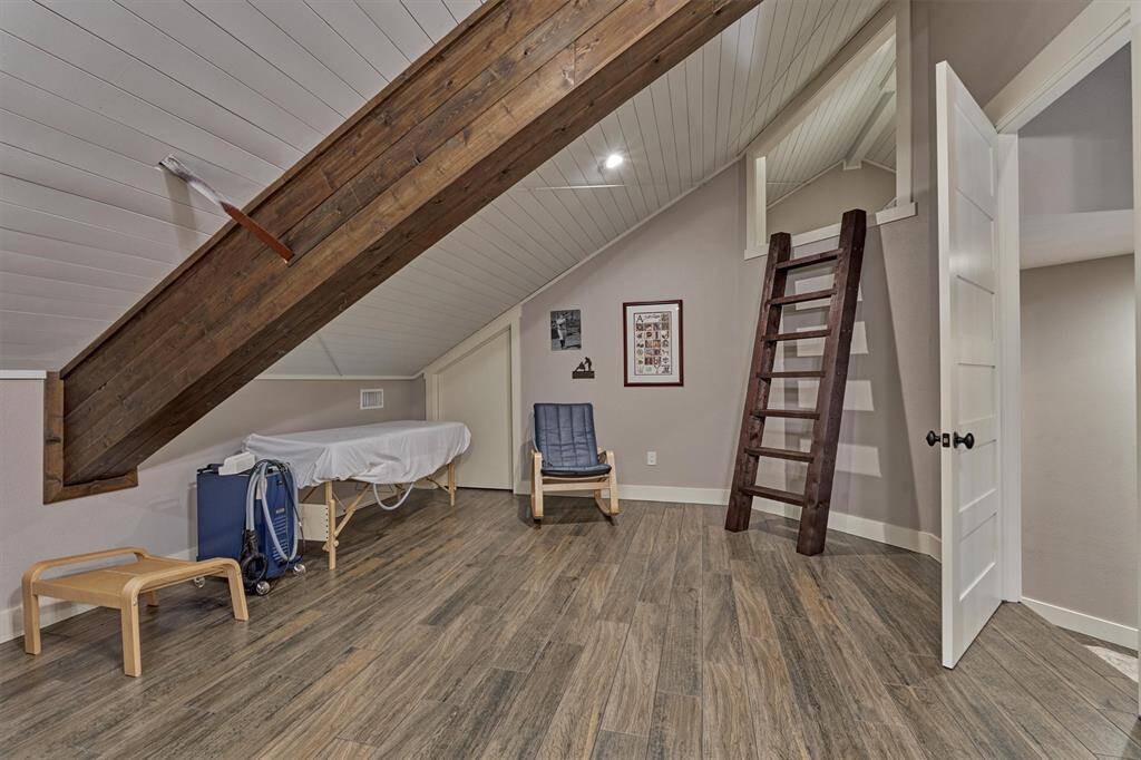 The wood beams continue in this space to continue the rustic aesthetic. A wooden ladder leads to a unique and fun loft area.