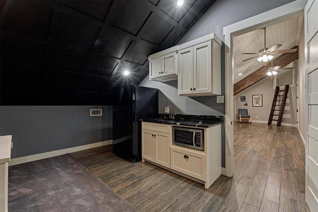 The convenient kitchenette in the media room is perfect for popping fresh popcorn or grabbing a cold drink without missing a moment of the action.