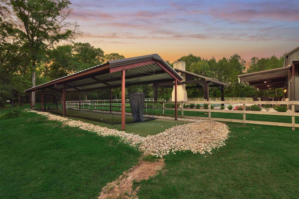 A full batting cage on the property is perfect for the aspiring major leaguer in training. This versatile covered space could also be repurposed for other recreational activities or additional covered space