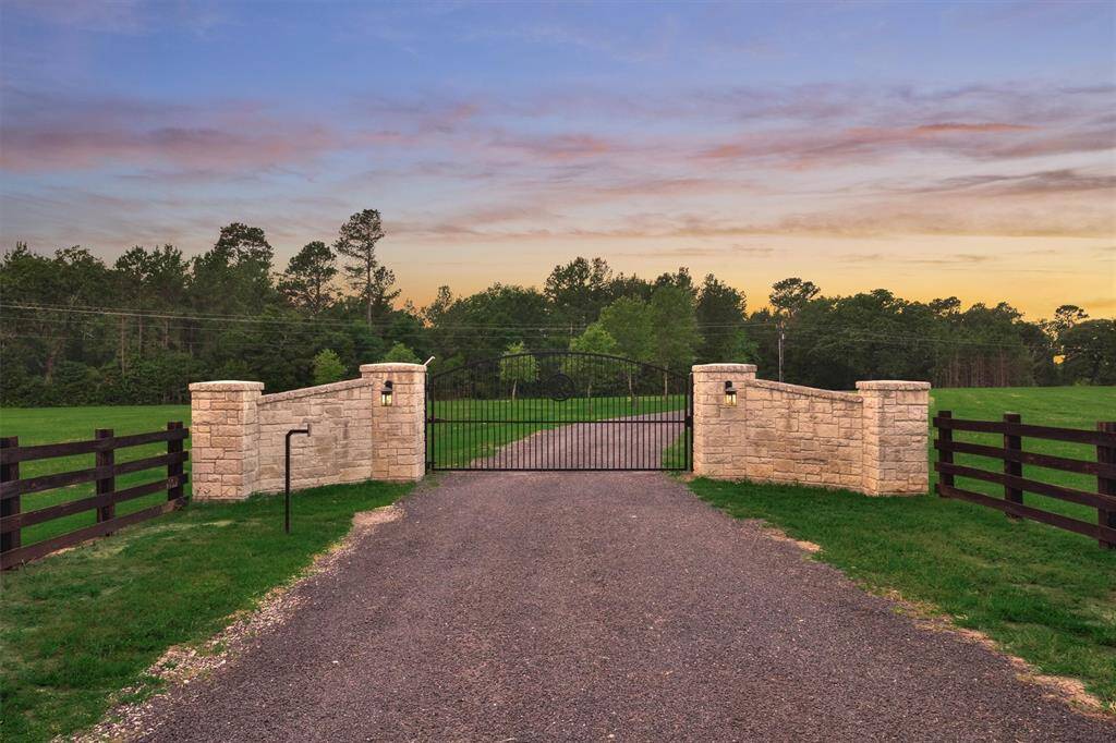 The gated entry to this property provides privacy and security. The stone surround complements the stone on the home.