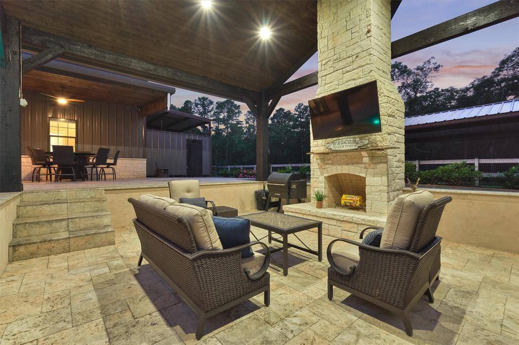 The elegant travertine pool surround continues into this area, creating a cohesive and sophisticated outdoor space.