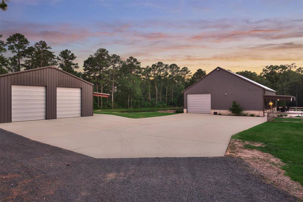 Upon entering the property, there is plenty of parking for guests, RVs, boats or other vehicles and equipment. The large shop on the left features two large roll up doors on the driveway side and opposite side for easy access.