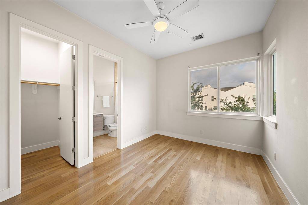 Features include a spacious walk-in closet and direct access to a sleek ensuite bath, providing comfortable living and added convenience within the home’s contemporary layout.
