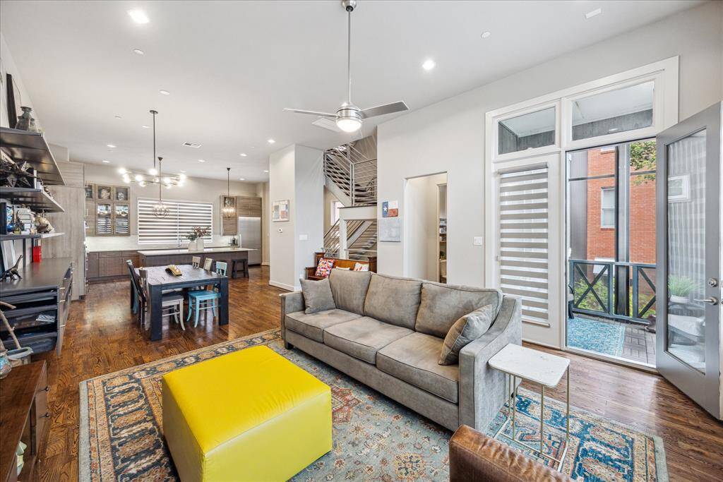 Bright and inviting, this welcoming living area blends style and functionality with generous windows and a seamless indoor-outdoor flow. The modern kitchen features contemporary cabinetry and fixtures, while direct access to a private balcony extends the living space, making it perfect for relaxed everyday living or effortless entertaining.
