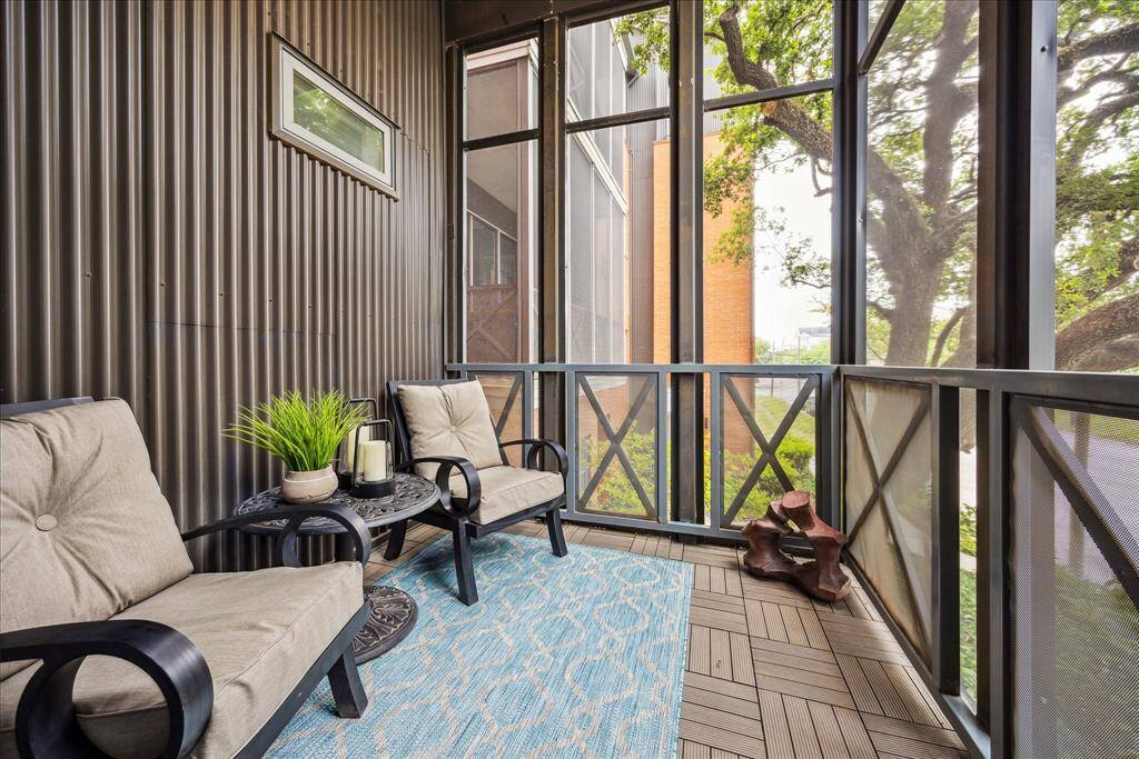 Unwind in this cozy screened-in patio, nestled among the treetops with peaceful views of lush greenery below. A perfect retreat for morning coffee or evening relaxation, this outdoor space offers rare tranquility right in the heart of Houston.